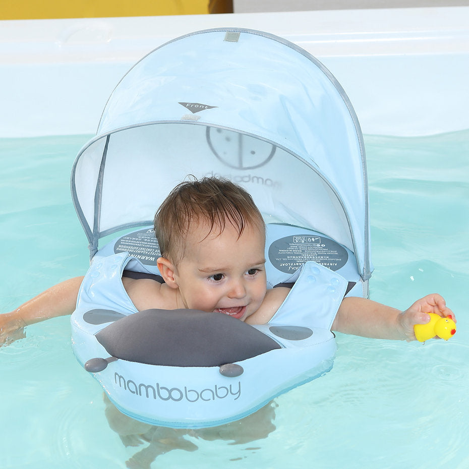 A toddler enjoying a holiday swim in the Mambobaby™ Ladybug Shoulder Float, promoting water confidence and leg movement.